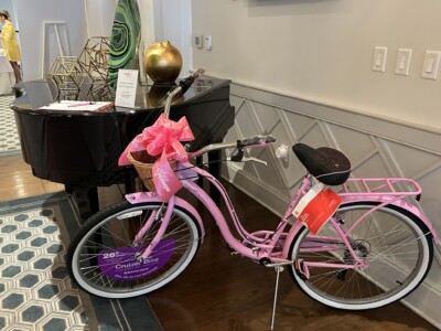 Silent Auction for a pink bike at 2024 May Day Brunch